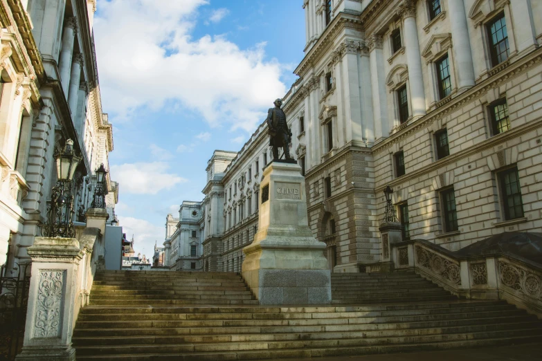 stone steps lead up to old town houses and a clock tower