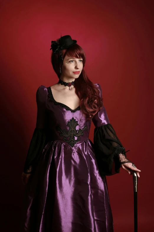 a lady in an old fashioned dress is posing