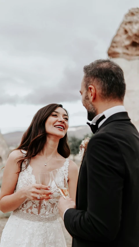 a bride and groom share a toast on their wedding day