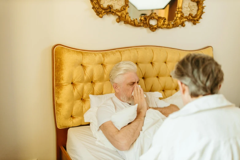 a woman in white sitting next to an older man