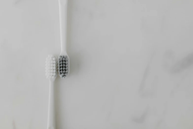 a toothbrush sits on a white surface