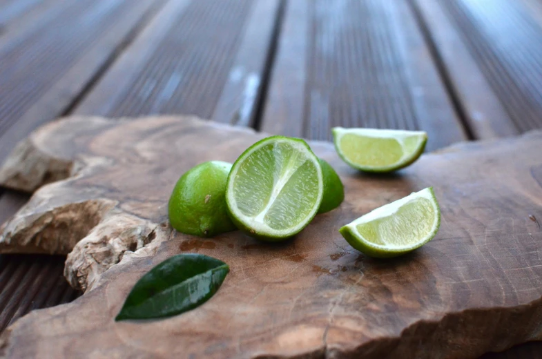 a lime sliced in half next to two pieces