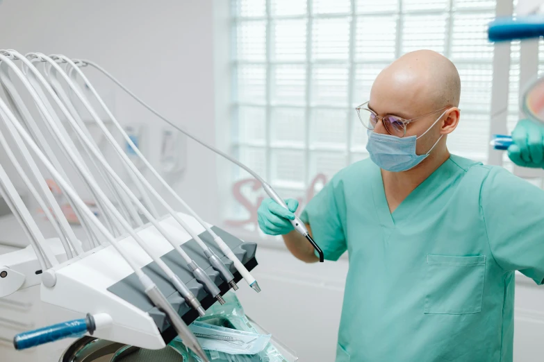 a man wearing glasses in a dentist room