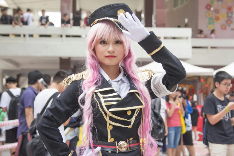 a girl in a military uniform poses with her hand up