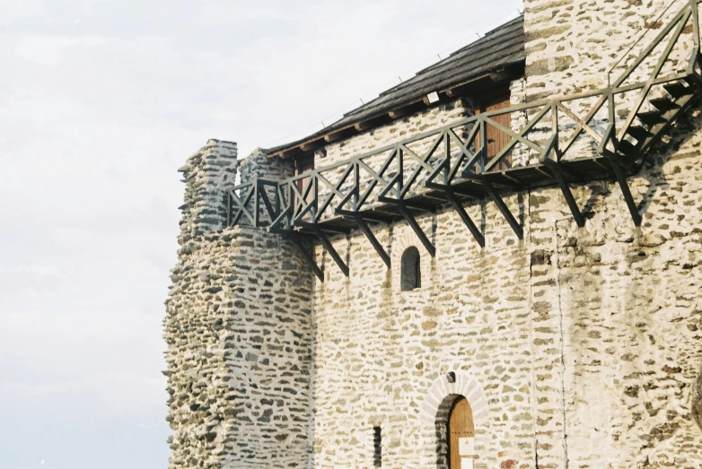 an old stone tower has metal railings that lead to it