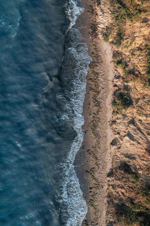 a sandy beach is seen from above