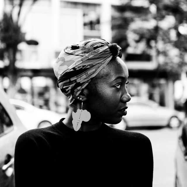 black and white po of a woman with a scarf on her head