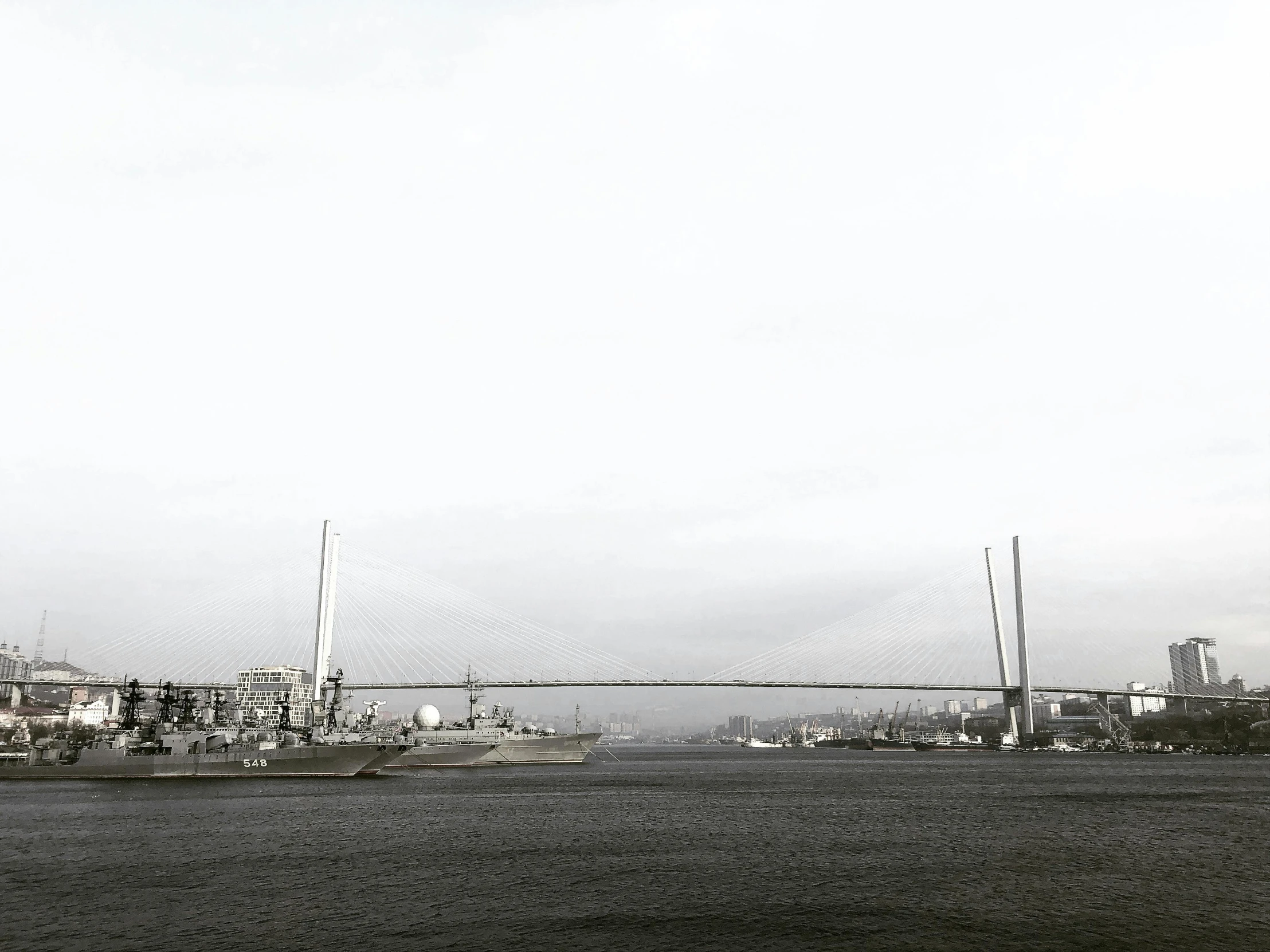 several ships in the water near buildings