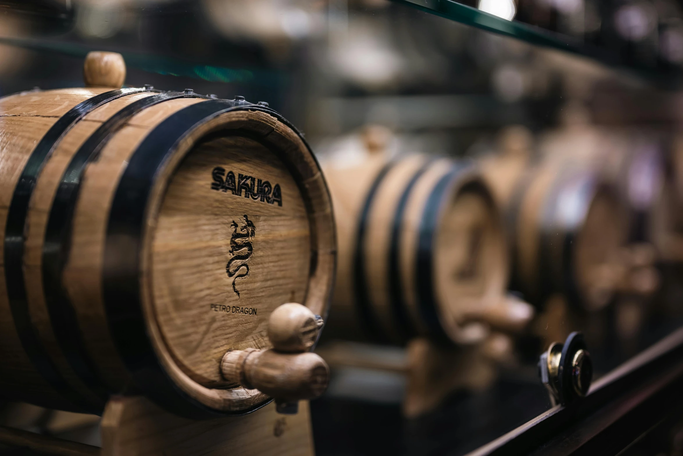 a wooden barrel is standing up with some wine glasses on it