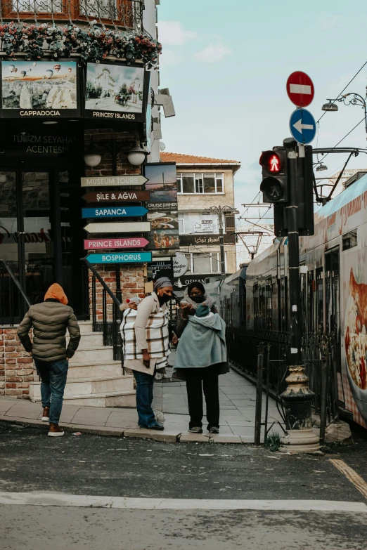 a couple of people walk on a sidewalk