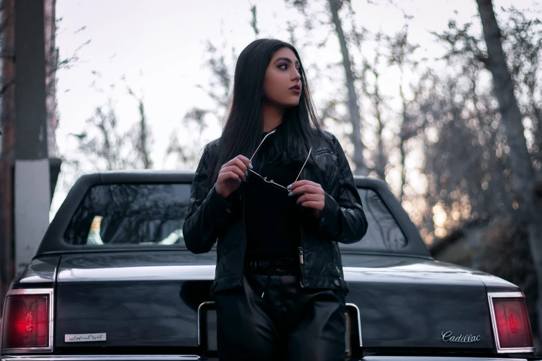 a woman standing in front of a truck holding soing up to her chest