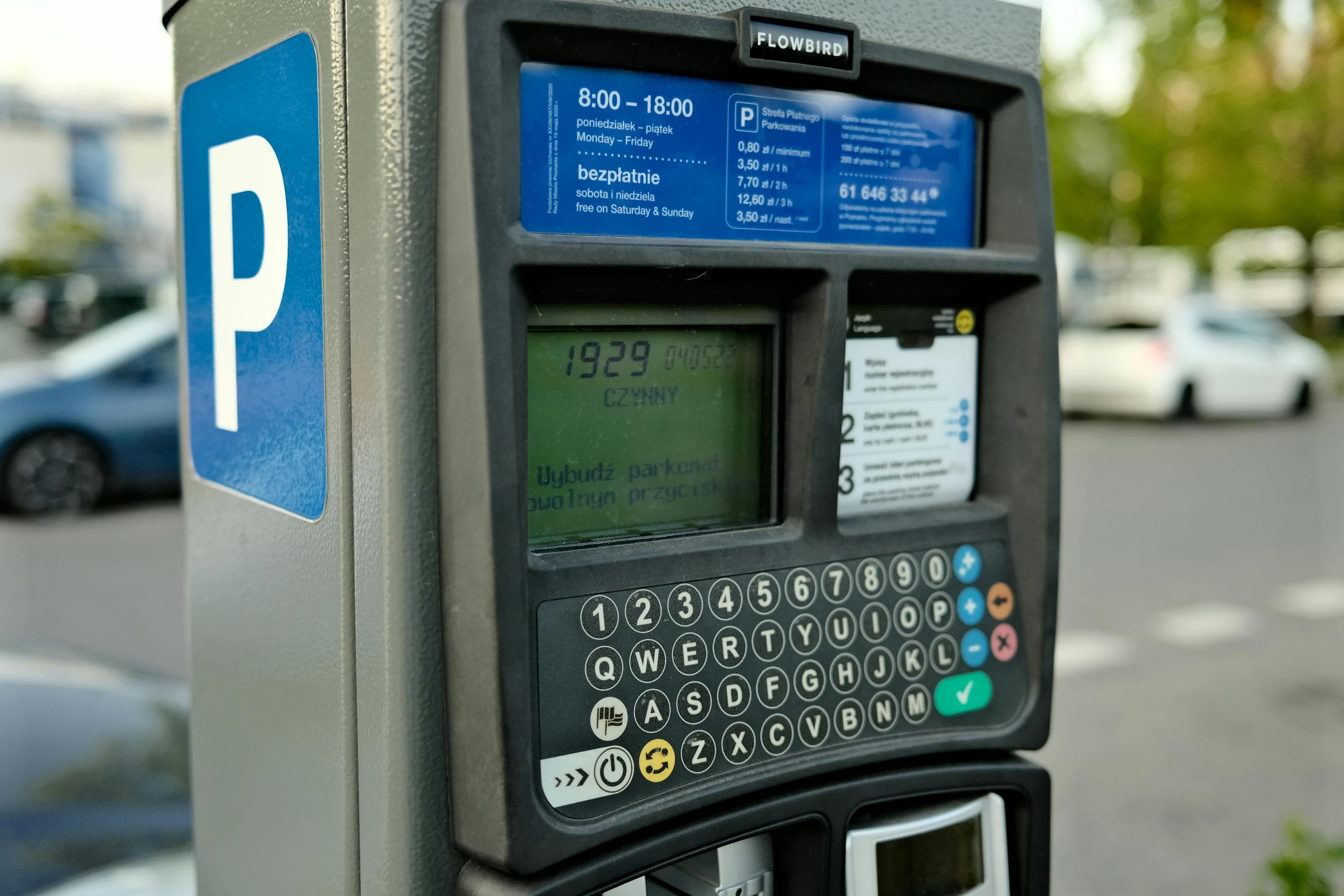 an electronic parking meter at the curb on a city street