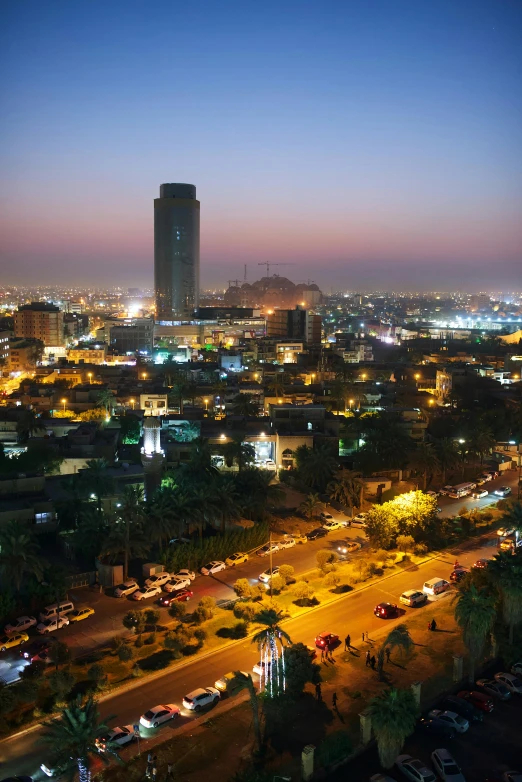 the city skyline is lit up at dusk