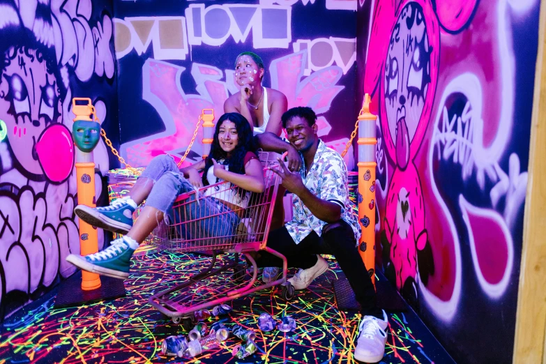 three people in an indoor graffiti store posing for the camera