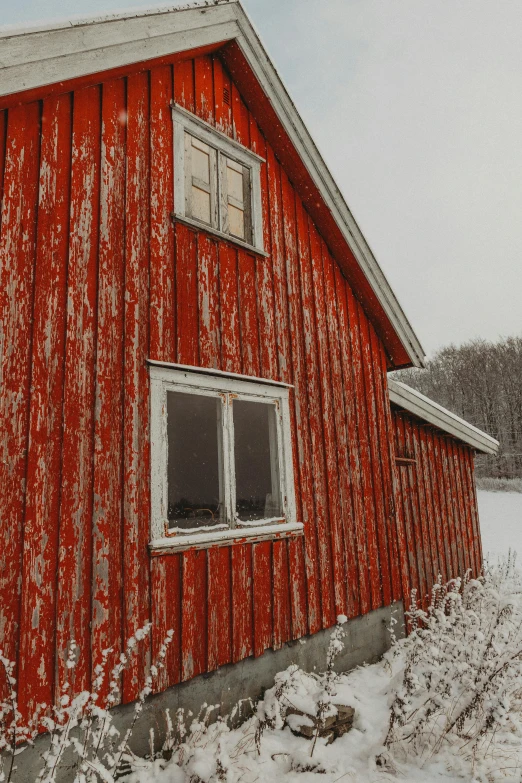 a red building that is sitting in the snow