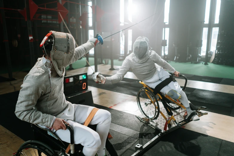 a woman with a wheelchair riding behind two men