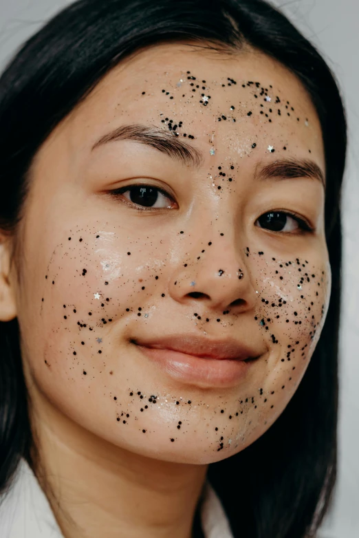 this is a beautiful young lady with black dots on her face