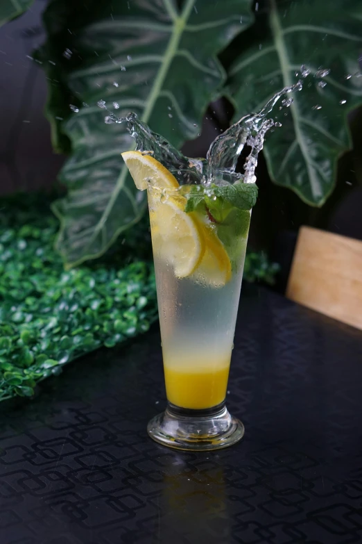a cocktail with a splash of water on top