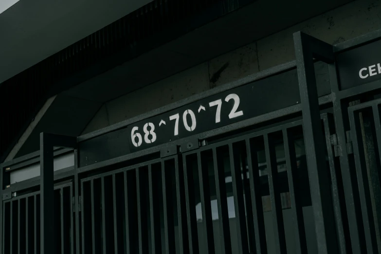 a gated building with signs on the front saying 6 08 to 7 12