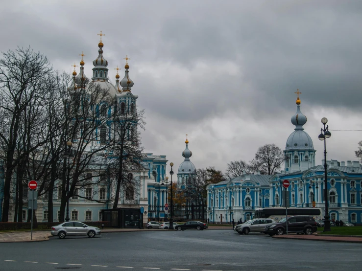 the building is blue and white and has gold domes