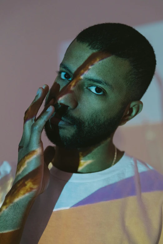 a man standing in front of a mirror with his hand on his face