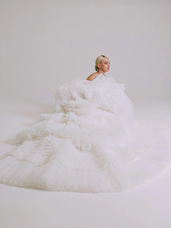 a woman in a wedding dress is covered in white stuff