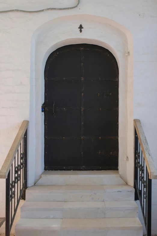 black and white pograph of steps and doors leading up