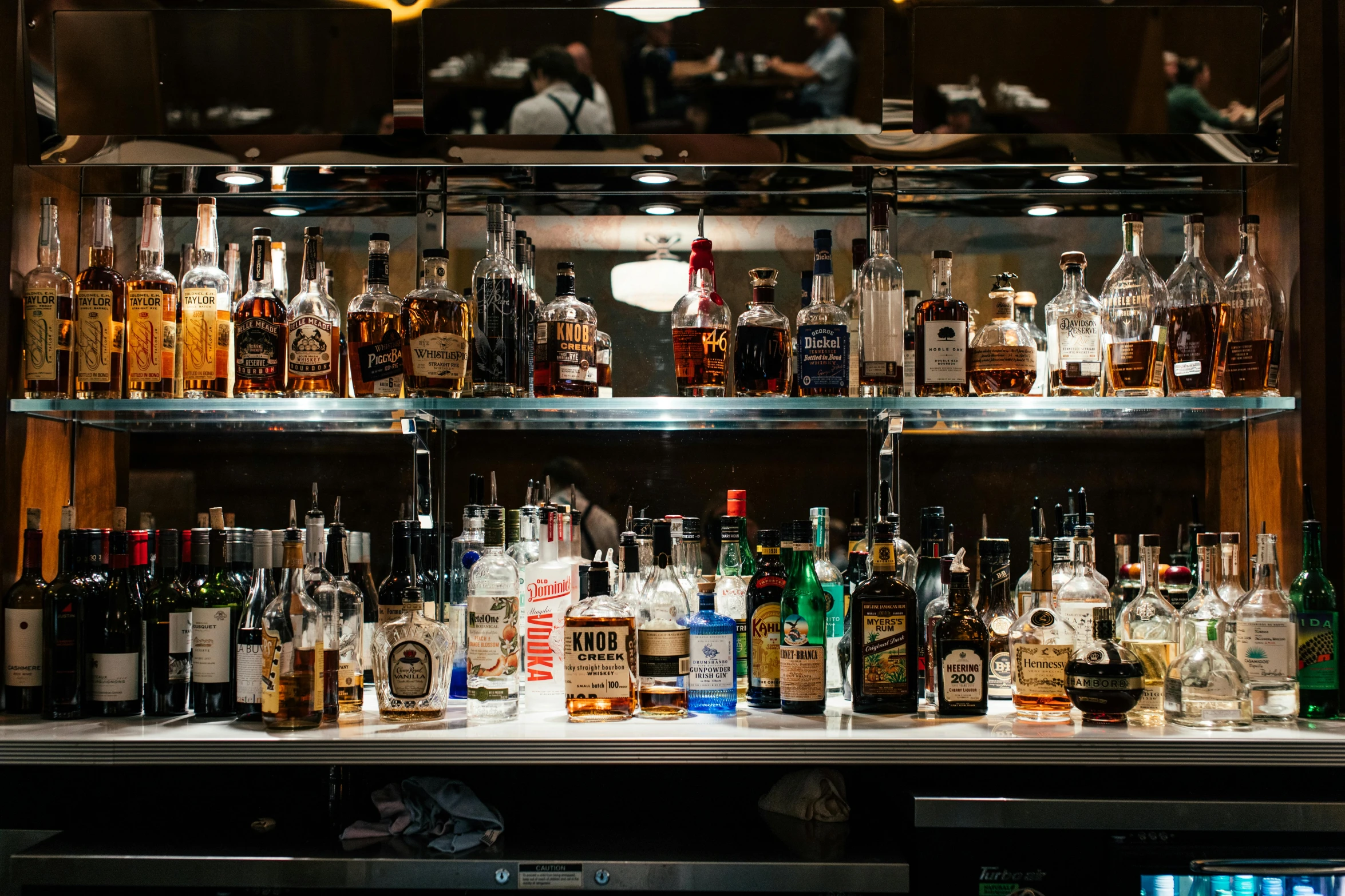 an assortment of different bottles of liquor on display in a bar