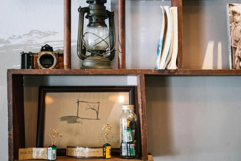 an empty wooden shelf is displaying various items