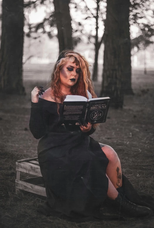 the woman has painted the lips and is reading a book