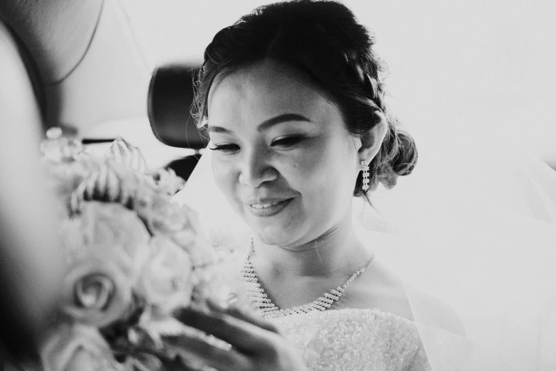 a woman in a dress standing and holding a bouquet