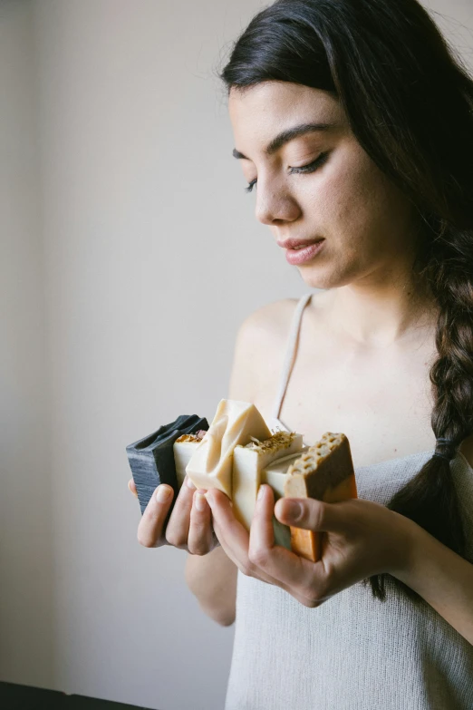 a woman holds a bundle of chocolate and bananas