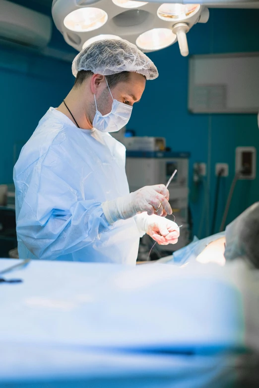 a surgeon preparing a patient for  in the operating room