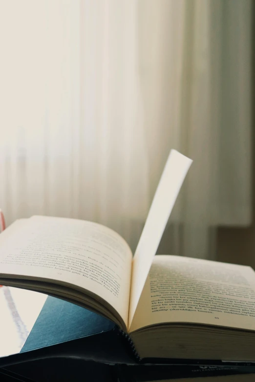 open book showing page of text placed on a table