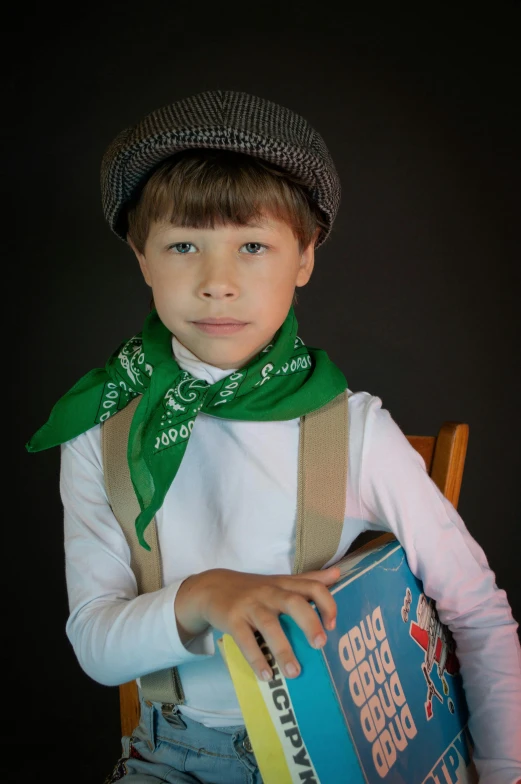 a small child is wearing overalls and holding a soda