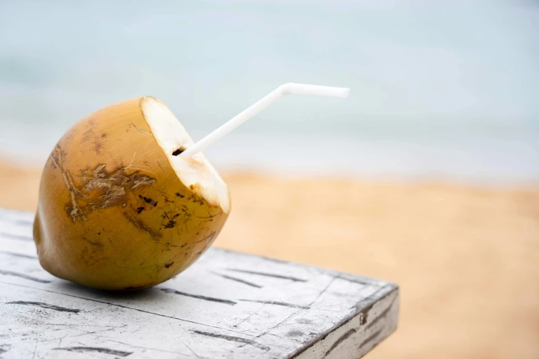 a piece of food sitting on top of a table near water