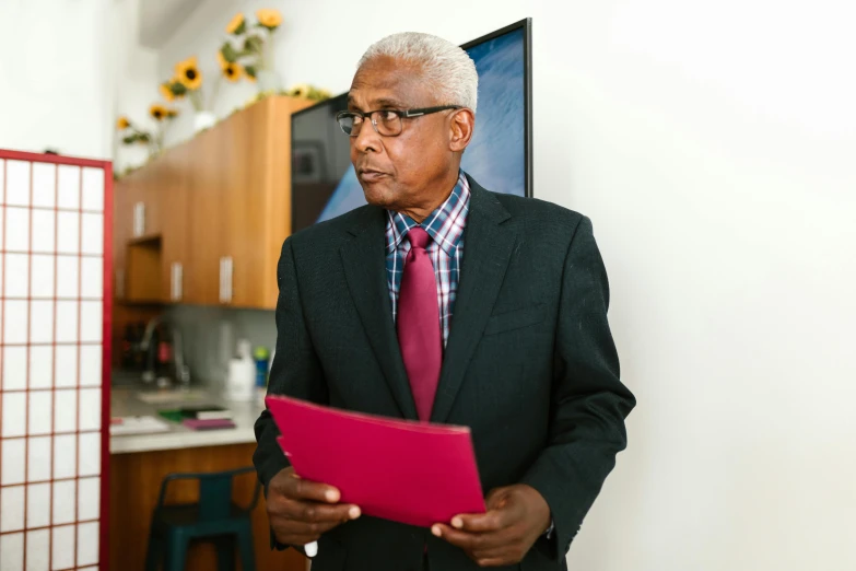 the man is wearing glasses and an purple tie