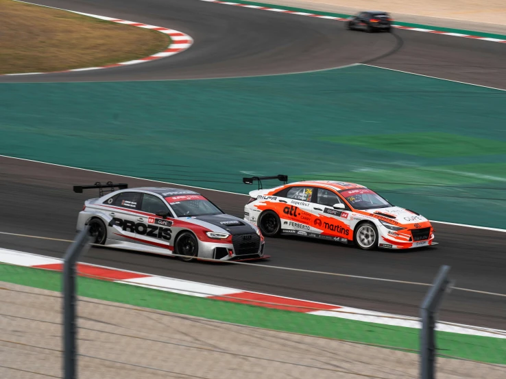 two race cars racing around an empty track