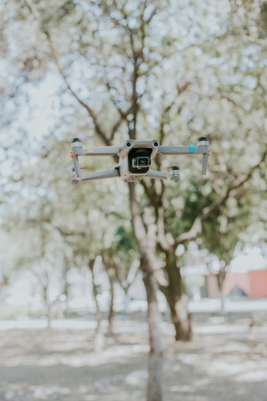 a camera suspended in the air above a street