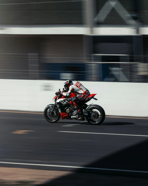 a person on a motorcycle driving down the street