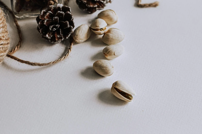 nuts and other nuts are scattered next to a small bowl