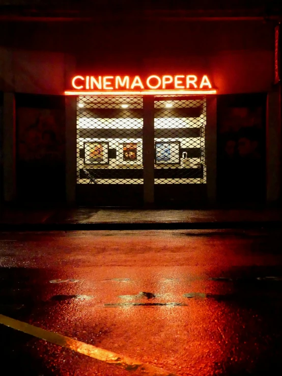 a city street with a dark store lit up at night