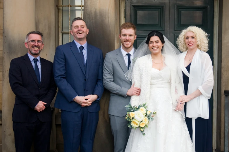 two couples and their bridally posing for the camera