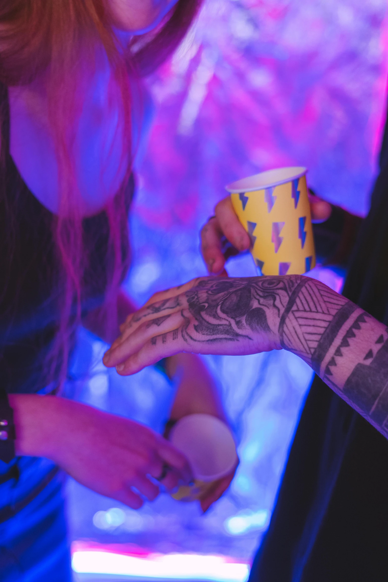 some very pretty tattooed hands with some cups
