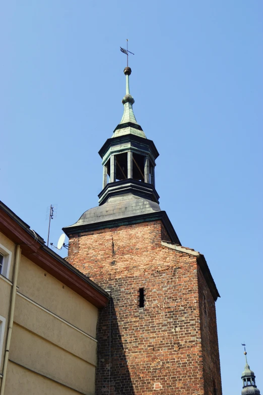 the clock is on top of the building near a building