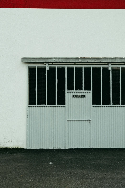 a white wall with a window and a sign