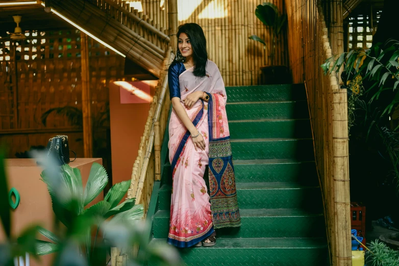 a woman is standing on the stairs outside