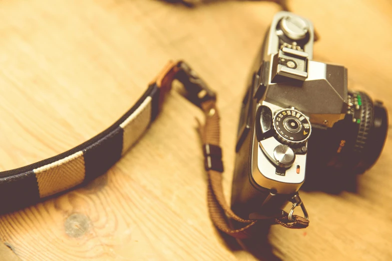 a picture of a vintage film camera on a wooden table