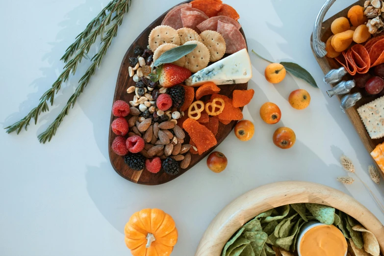 two wooden platters filled with assorted food items