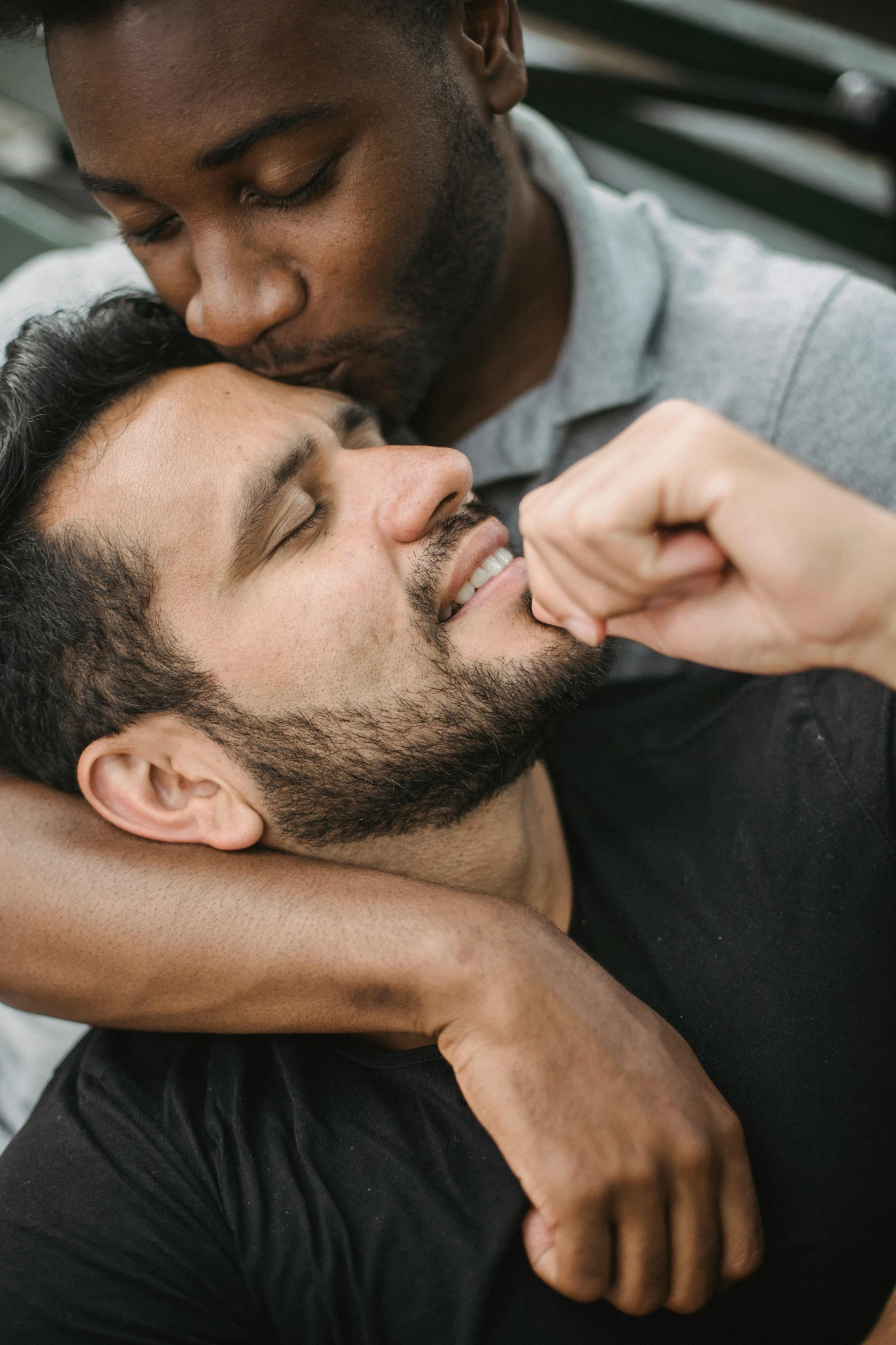 a man is rubbing the chest of another mans shoulder